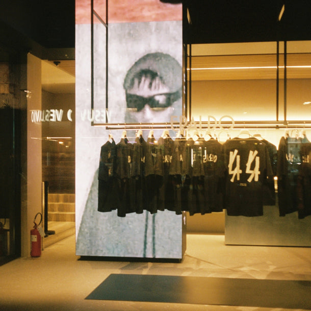 44 Label Group AW24 collaboration T-shirts displayed in the Eraldo Store Jesolo window, with illuminated 44 Label Group visuals on the LED screen behind them.