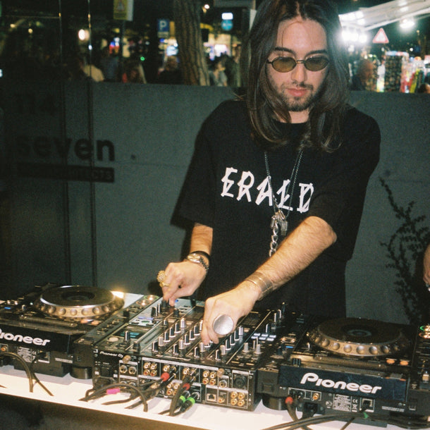 DJ performing during the 44 Label Group AW24 event at Eraldo Store Jesolo, wearing the exclusive collaboration T-shirt.