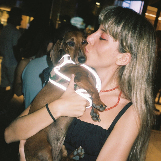 Guest holding and kissing her dachshund during the 44 Label Group AW24 event at Eraldo Store Jesolo.