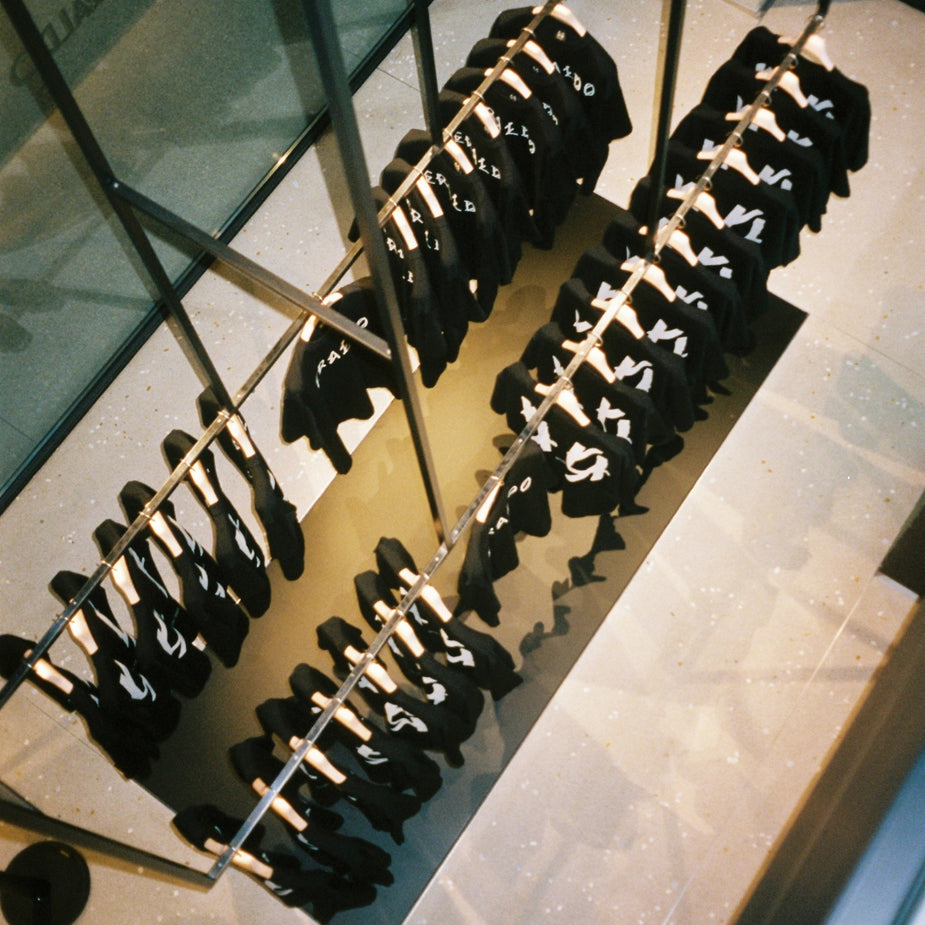 Exclusive 44 Label Group AW24 collaboration T-shirts displayed inside Eraldo Store Jesolo, photographed from above.
