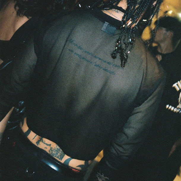 Guest wearing a black sheer T-shirt from the Ann Demeulemeester AW25 collection during the event at Eraldo Store Jesolo.