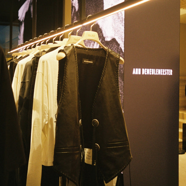 Ann Demeulemeester AW25 garments displayed inside Eraldo Store Jesolo with the Ann Demeulemeester logo shown on the LED screen behind them.
