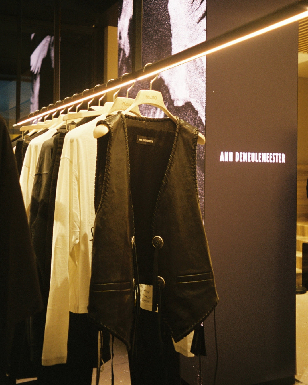 Ann Demeulemeester AW25 collection displayed in the Eraldo Store Jesolo window, with the brand logo on the LED screen behind the garments.