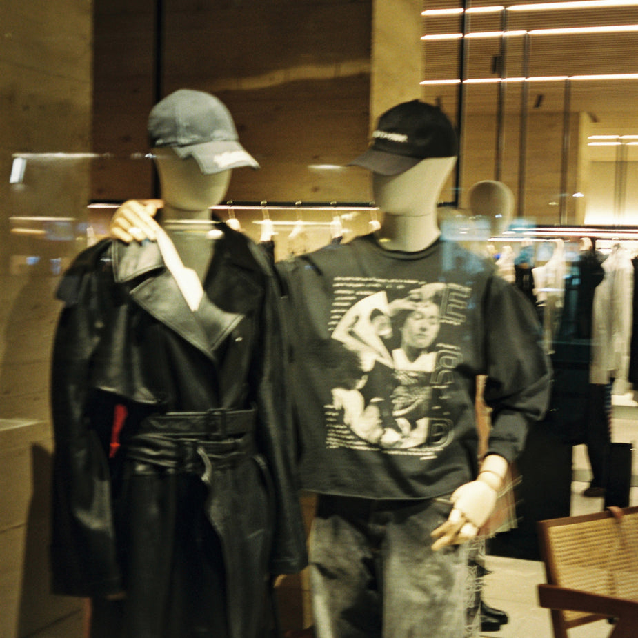 Mannequins wearing pieces from the Ann Demeulemeester AW25 collection displayed in the Eraldo Store Jesolo window during the event.