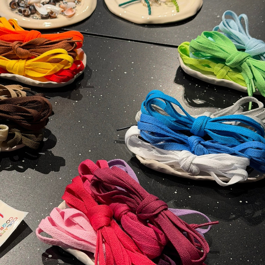 Colorful laces available for customizing sneakers during the Eraldo x Collanine Colorate sneaker customization workshop 2026.