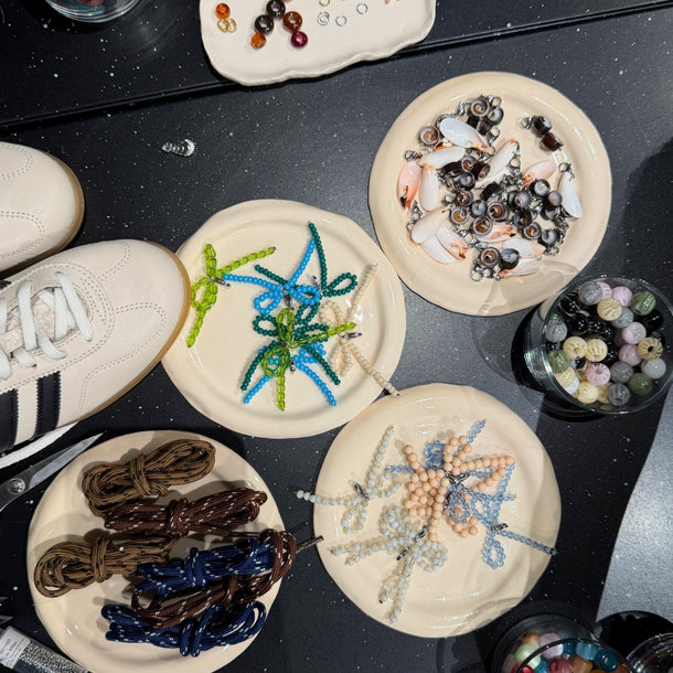 Collanine Colorate workshop table with colorful laces and beads used to customize sneakers during the 2026 Eraldo event.