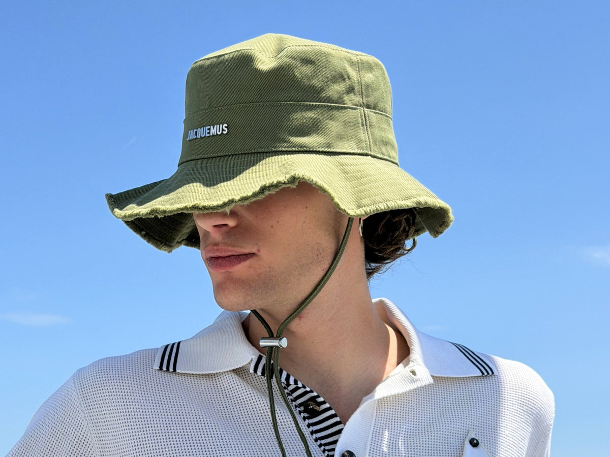 Men's Fall Winter 2026 new arrivals featuring a Jacquemus green bucket hat with fringe details