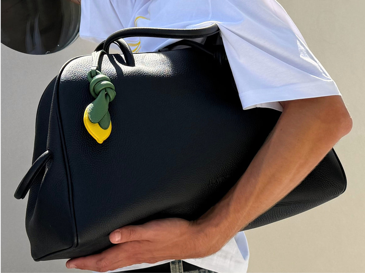 Men's Fall Winter 2026 new arrivals featuring the Jacquemus The Turismo Soft Bowling Bag in grained leather with a bow detail.