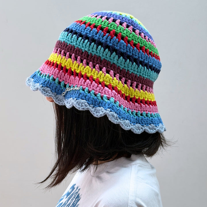 Women's designer hats selection featuring a Ganni multicolor knit hat with a colorful textured design