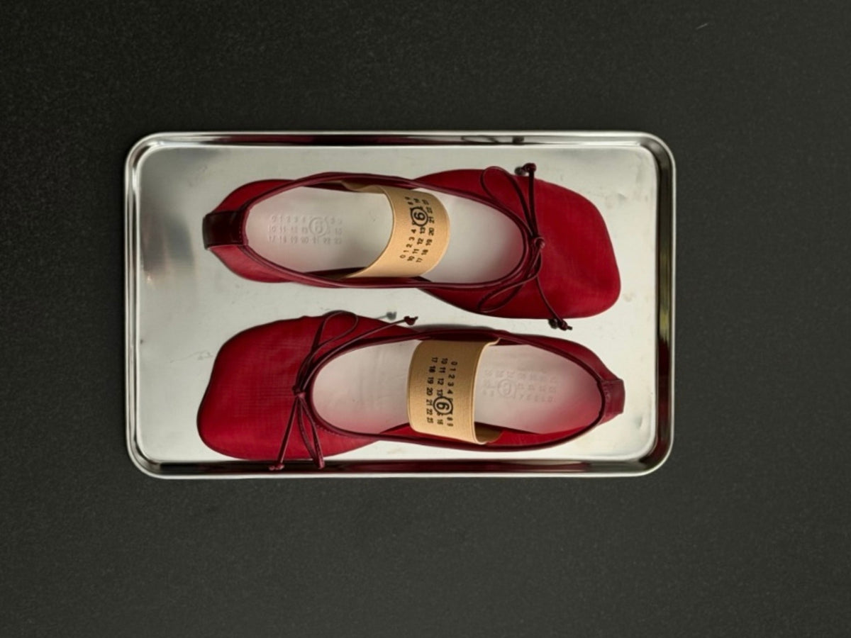 Women's Fall Winter 2026 new arrivals featuring MM6 Maison Margiela red transparent mesh ballerinas with an Anatomic toe, bow detail and Numeric logo elasticated strap.