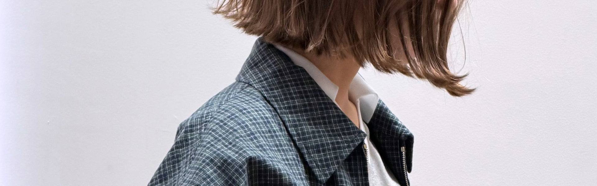 Women's Fall Winter 2026 new arrivals luxury fashion outfit by Miu Miu with a white collar polo shirt and a green and blue checked jacket