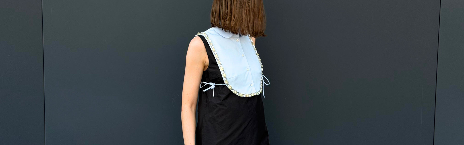 Women's Fall Winter 2026 new arrivals featuring a Prada crystal-embellished mini dress with a bib detail.