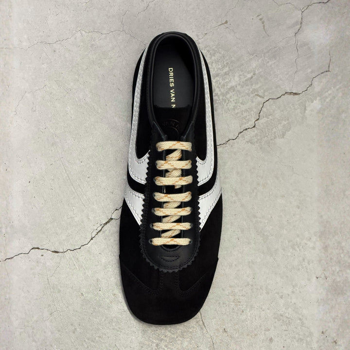 Men's Fall Winter 2026 new arrivals featuring Dries Van Noten black leather sneakers with suede panels and side stripe detail.