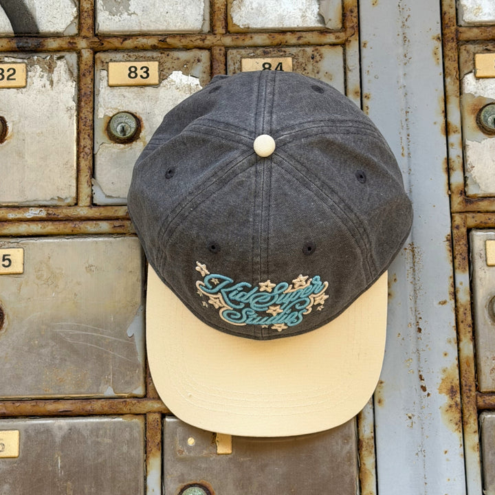 Grey cap by KidSuper with blue and cream details
