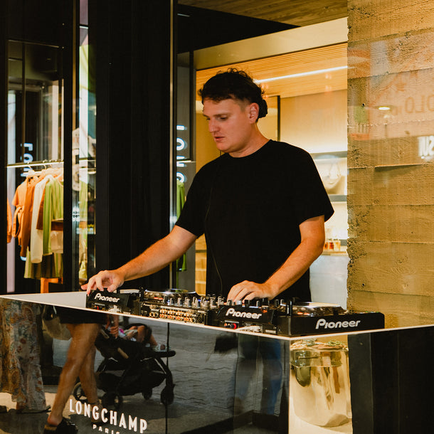 DJ set at the Longchamp AW26 event featuring a custom Eraldo x Longchamp Paris branded booth at Eraldo Store Jesolo.