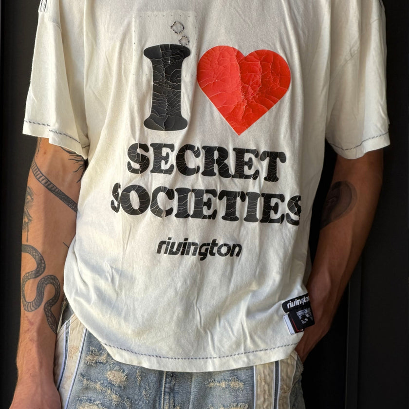 Man wearing Rivington Roi Rebis Spring Summer printed T-shirt styled with bermuda shorts and distressed jeans.