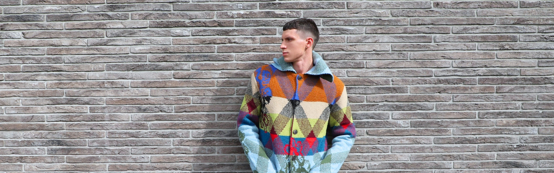 Model wearing a multicolor wool coat by Dries Van Noten.