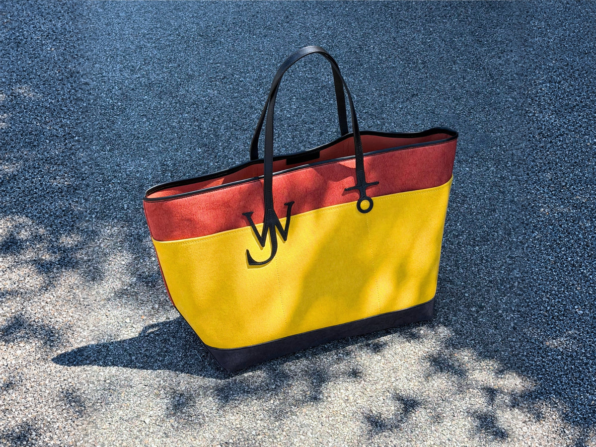 JW Anderson tote bag in black, orange and yellow.