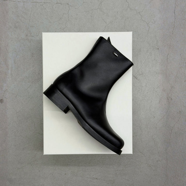 Men's New Arrivals 26 featuring Our Legacy Camion Boots placed on their box.