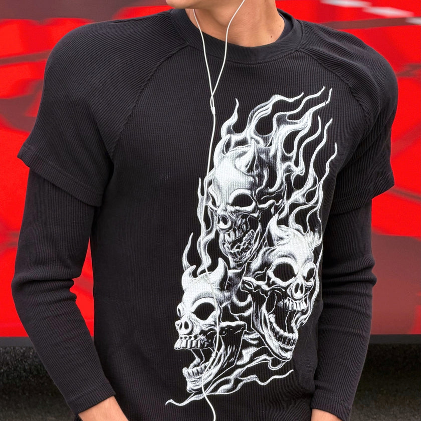 Model wearing a black printed long-sleeve T-shirt by Thug Club.