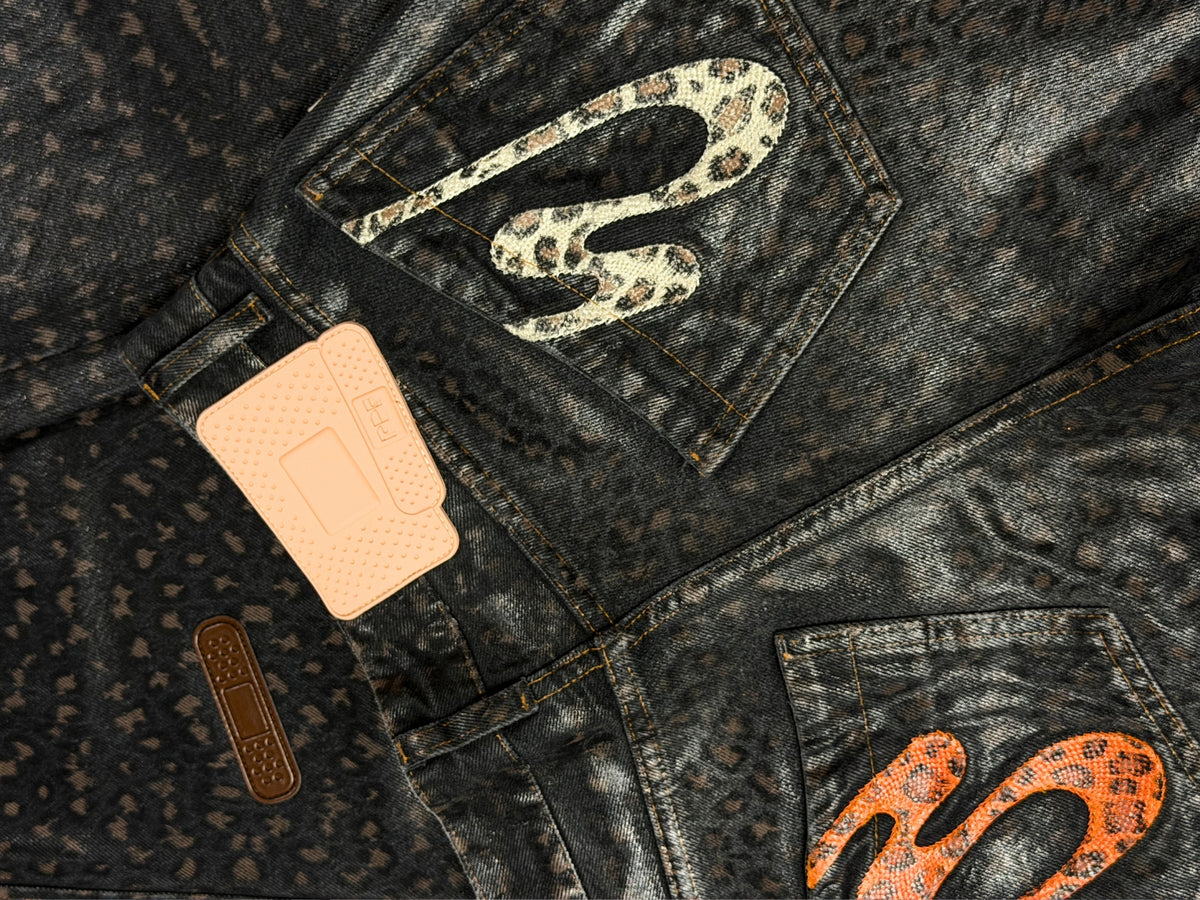 Black leopard print denim jeans with logo patch and belt loops by PDF
