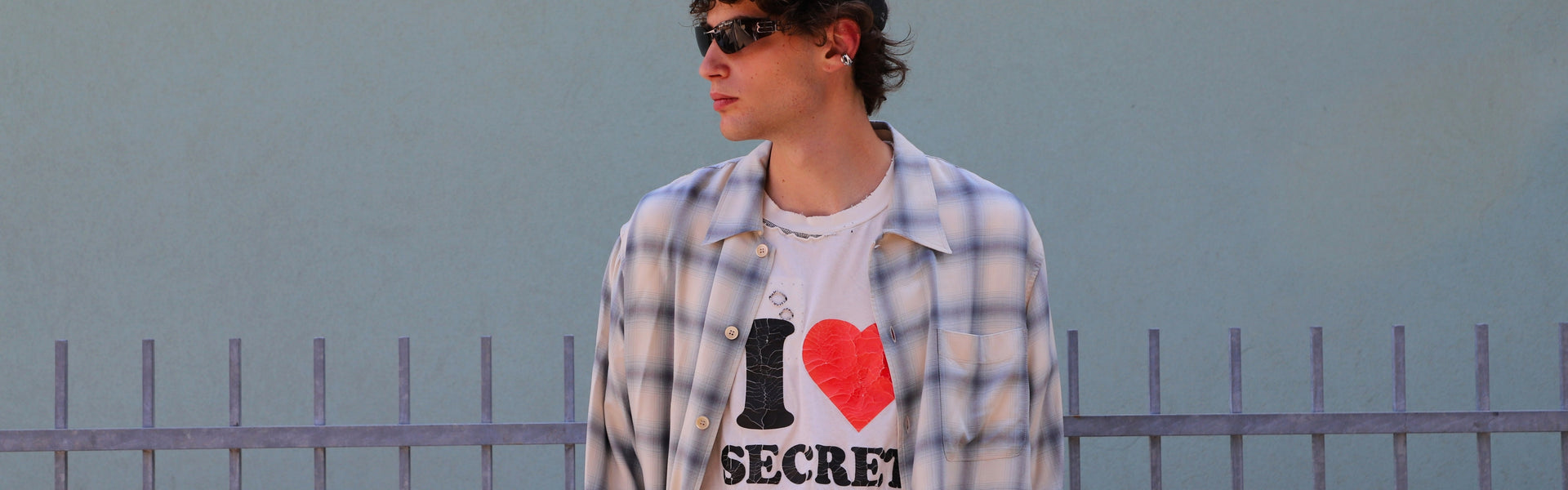 Man wearing a blue and white check shirt with chest pocket by Our Legacy from the men's shirts selection