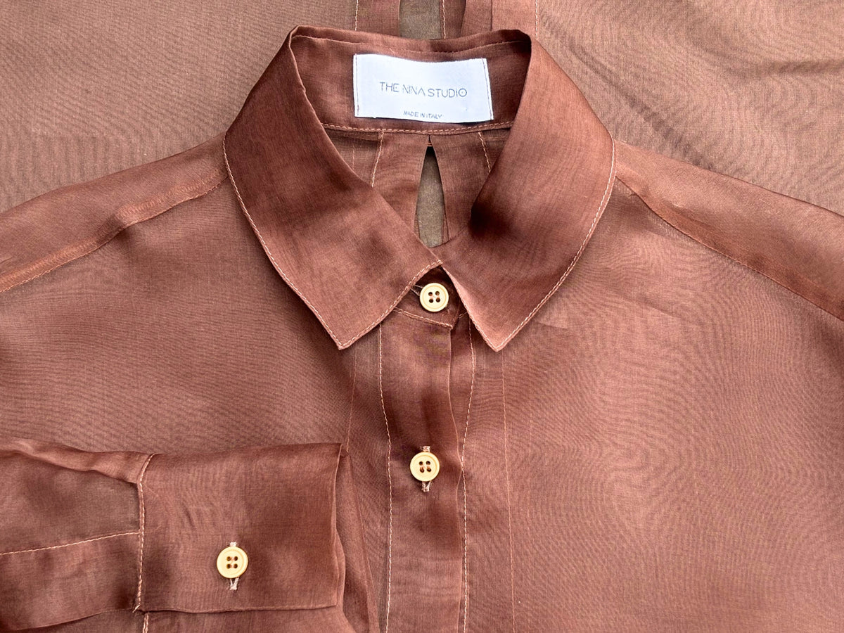 Woman wearing a sheer chocolate brown shirt by The Nina Studio from the Spring Summer womens clothing selection