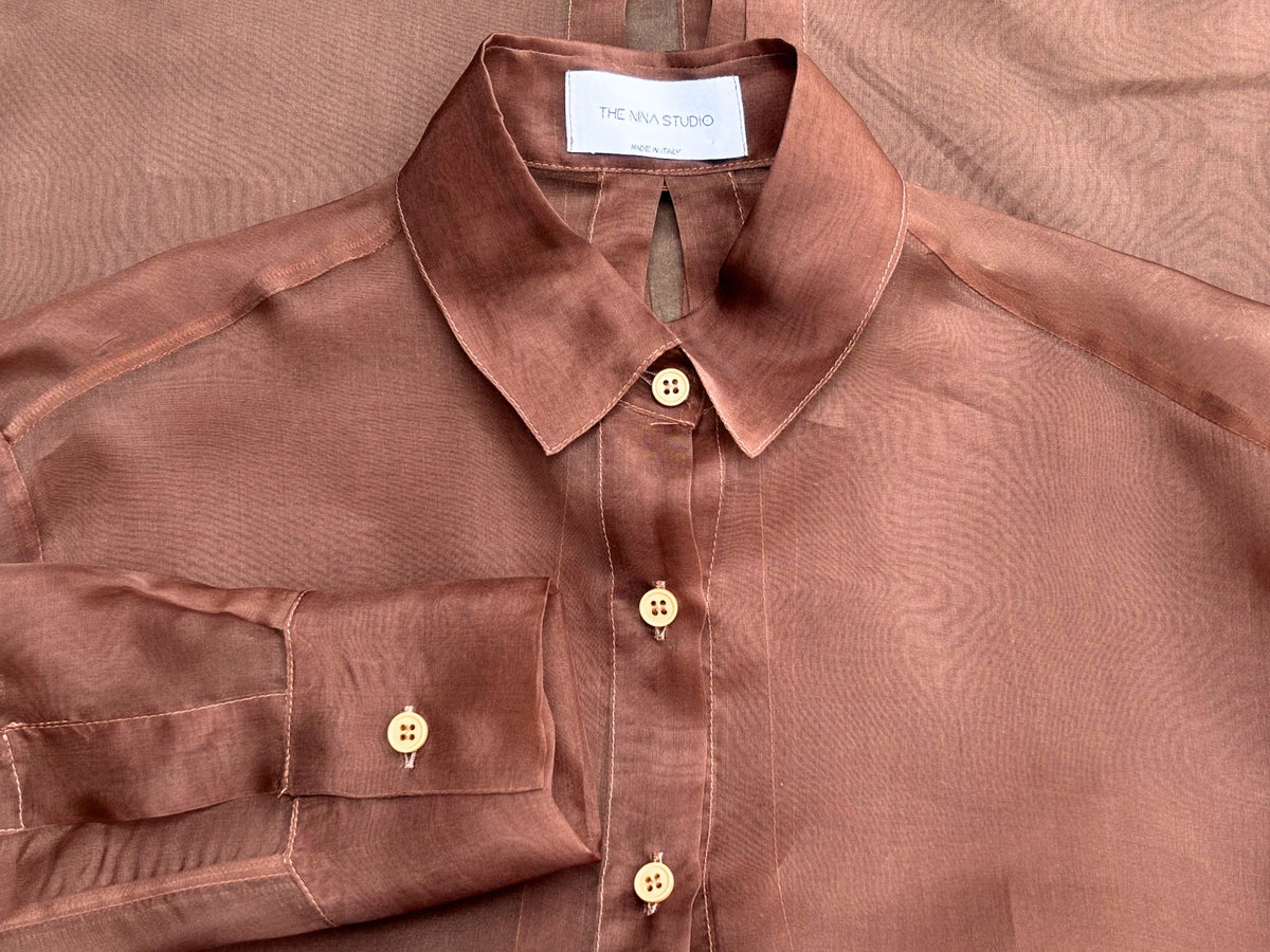 Woman wearing a sheer chocolate brown shirt by The Nina Studio from the Spring Summer womens clothing selection