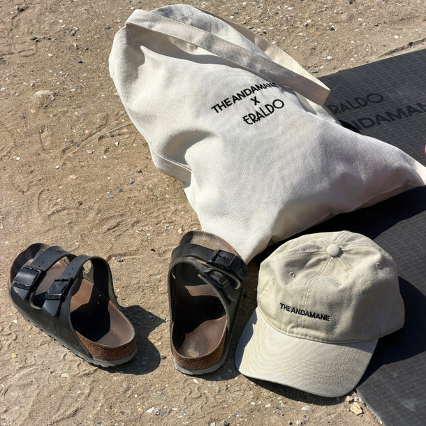 Eraldo x The Andamane branded canvas tote bag with a yoga mat on the beach during the AW26 A Morning by the Sea event.
