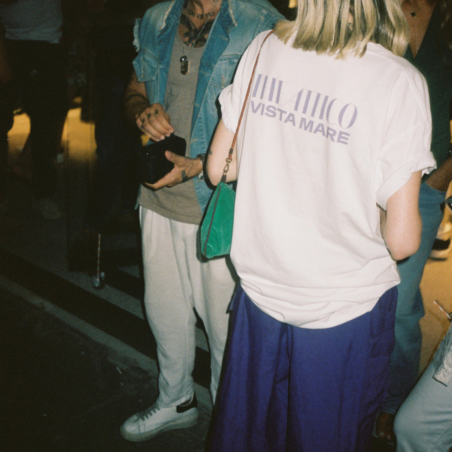Guest wearing the exclusive The Attico Vista Mare 2024 event T-shirt inside Eraldo Store Jesolo.