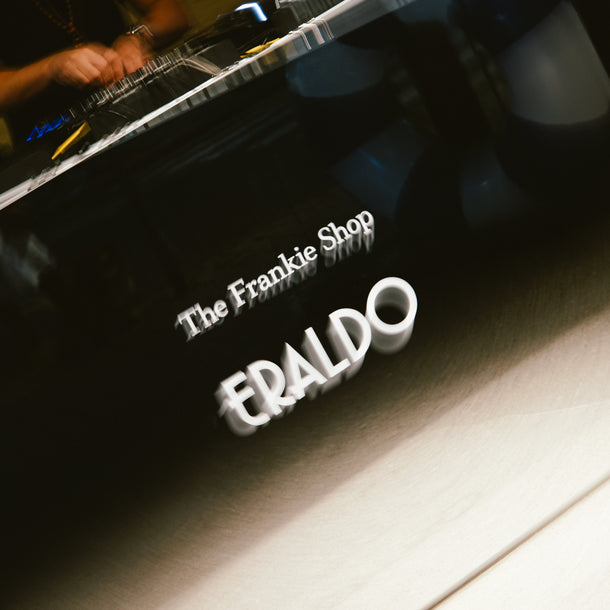 The Frankie Shop and Eraldo logos displayed on the DJ booth at the Summer Tour 26 event in Eraldo Store Jesolo